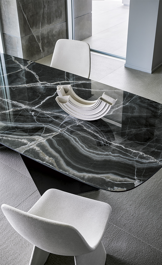 Dettaglio tavolo AX con piano in cristallo e gambe metalliche colorate