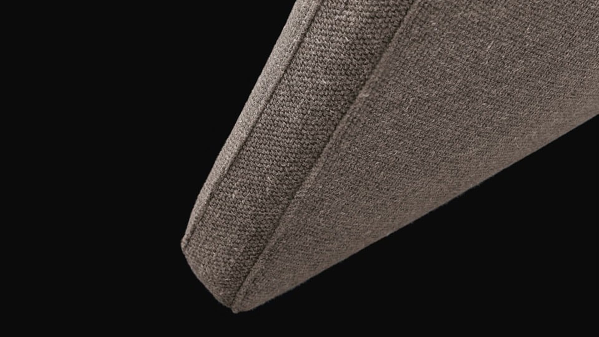 Dettaglio testata imbottita leggermente inclinata del letto Rever